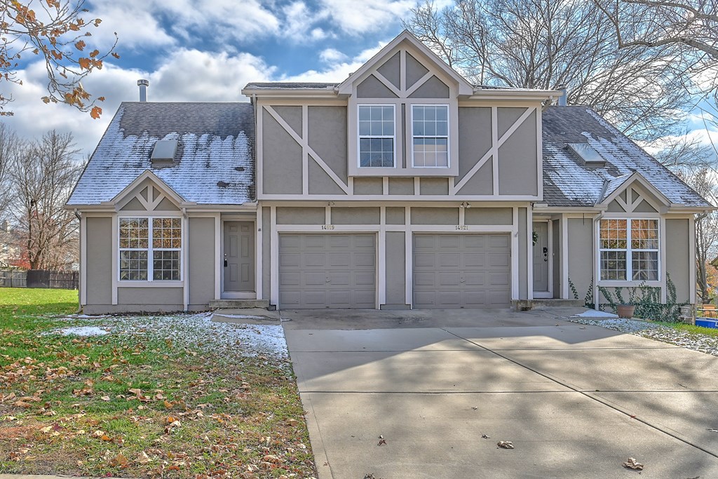 A house with a grey roof and white walls.