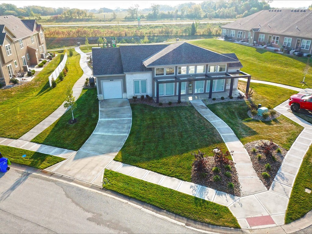 a house in a neighborhood with a walkway and lawn