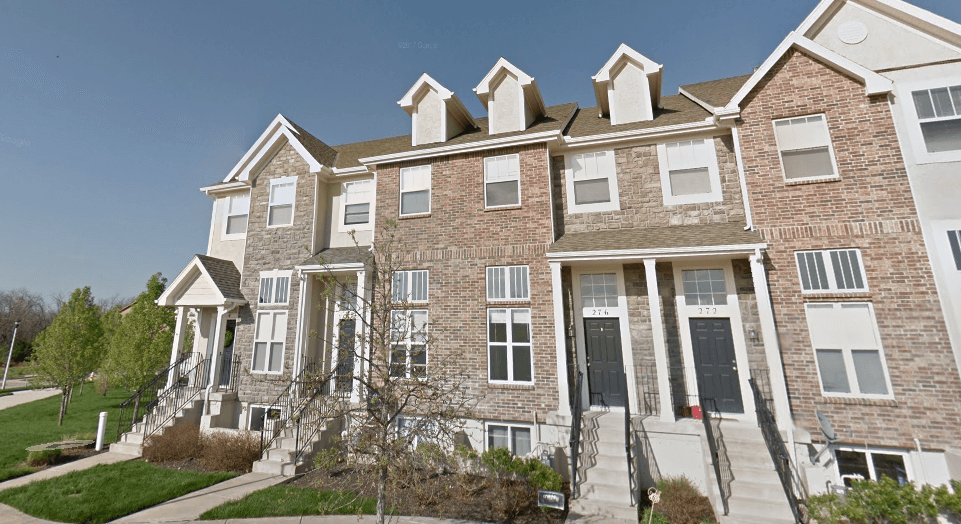 a row of brick apartment buildings on a sunny day