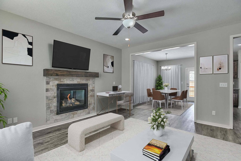 a living room with a fireplace and a table with chairs