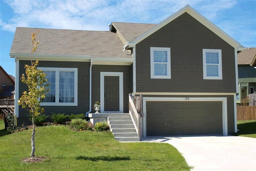 a brown house with a garage door