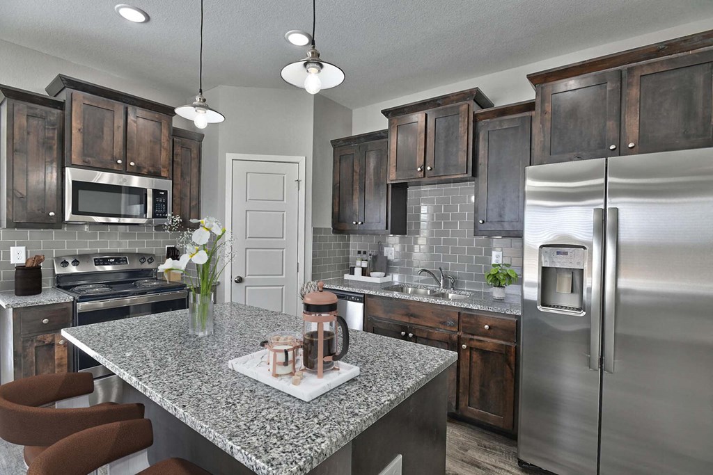 a kitchen with stainless steel appliances and granite counter tops