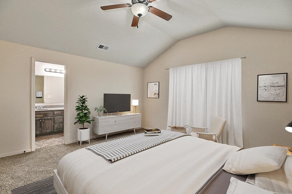 a bedroom with a bed and a ceiling fan