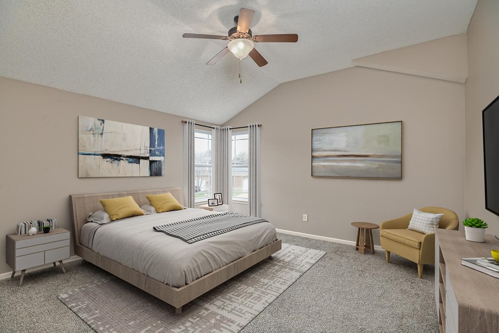 a bedroom with a bed and a ceiling fan