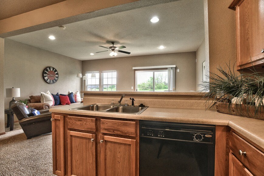 a kitchen with a sink and a ceiling fan