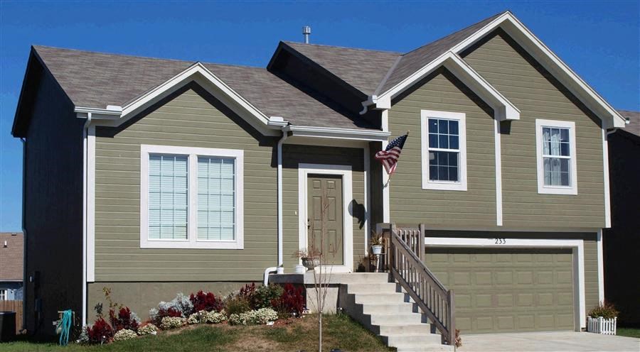 a green house with a flag in front of it