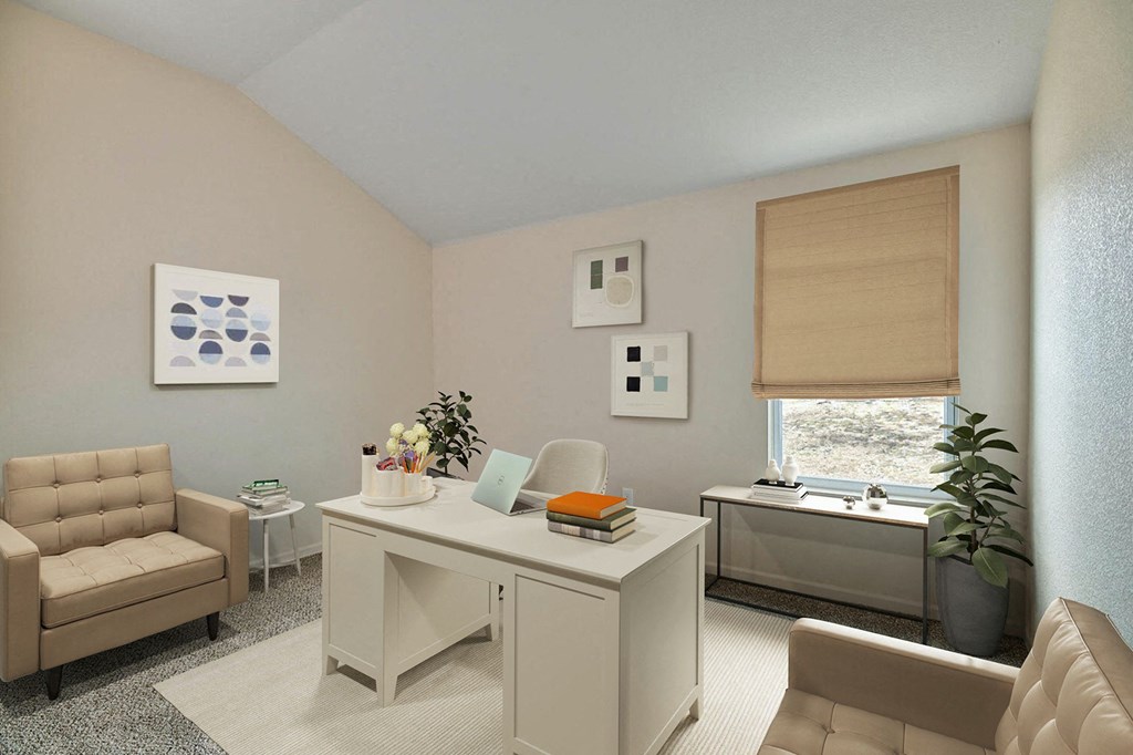 a living room with a desk and chairs and a window