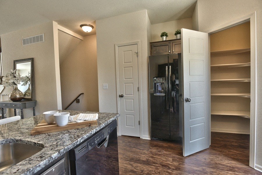 a kitchen with a counter and a sink and a door to a closet