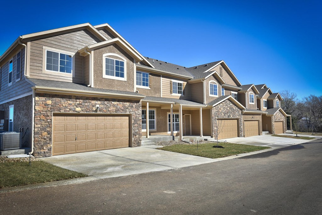 a tan and brown house with a garage
