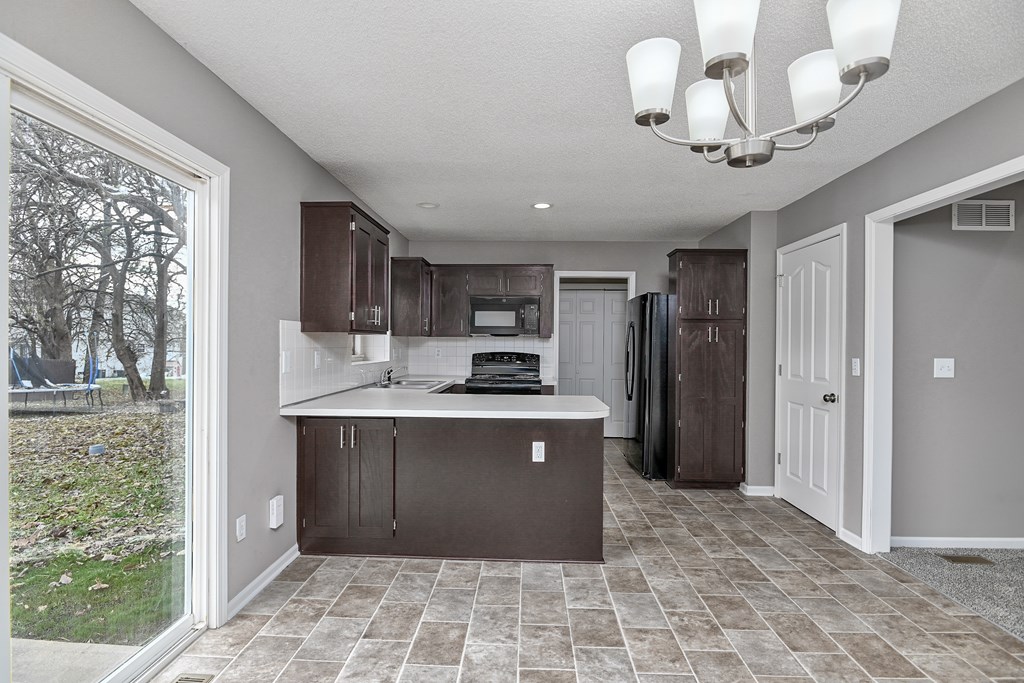 A kitchen with brown cabinets and a white countertop.