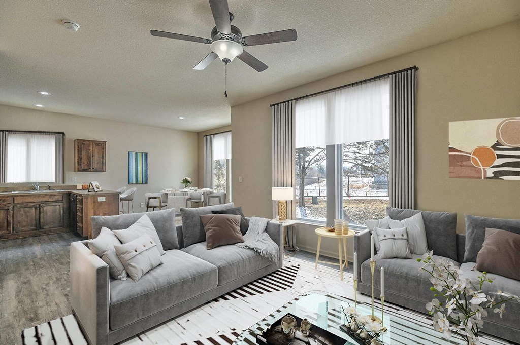 an open living room with couches and a glass table