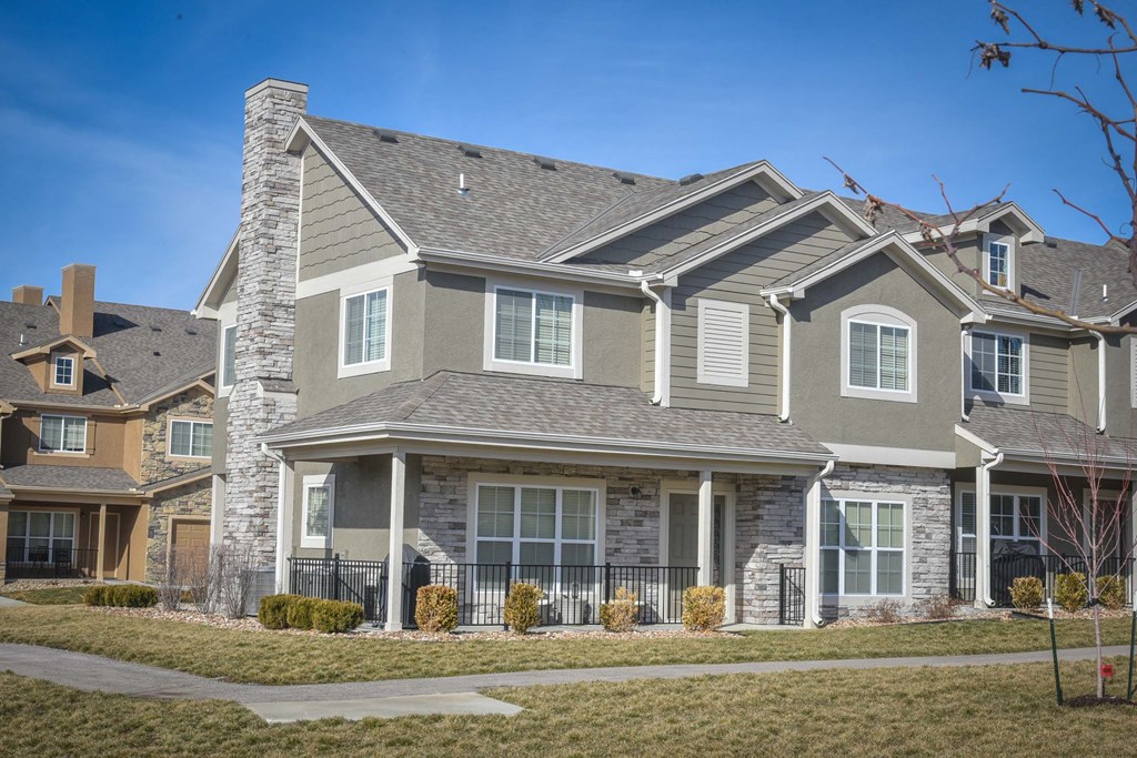 a large house with stone exterior and asphalt roof