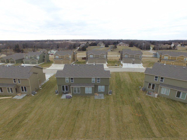 an aerial view of a group of houses in a field
