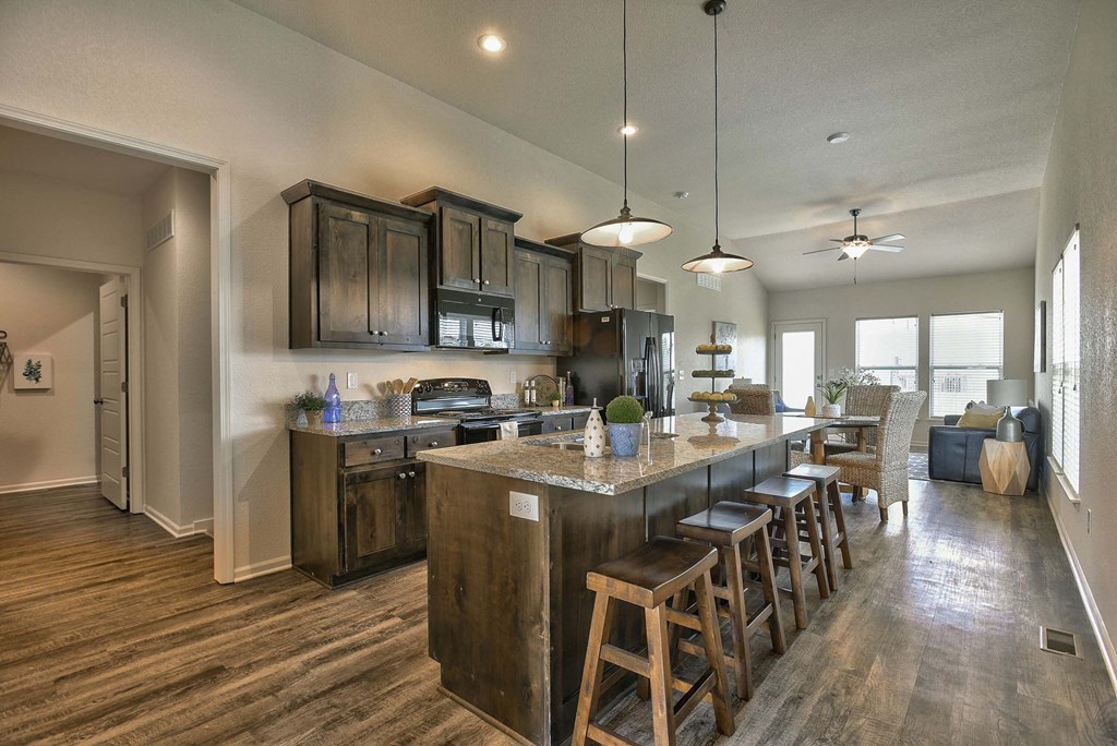 a large kitchen with a center island and a dining area