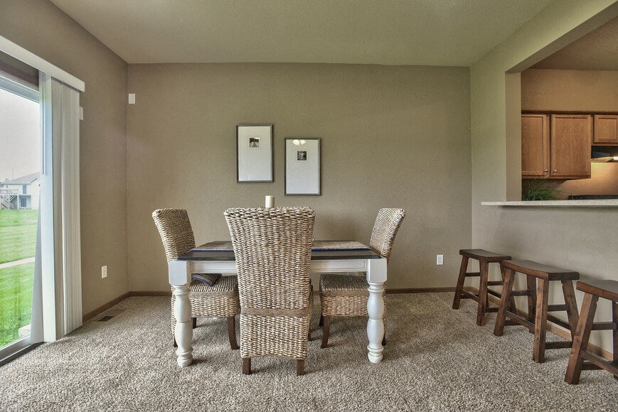 a dining room with a table and chairs