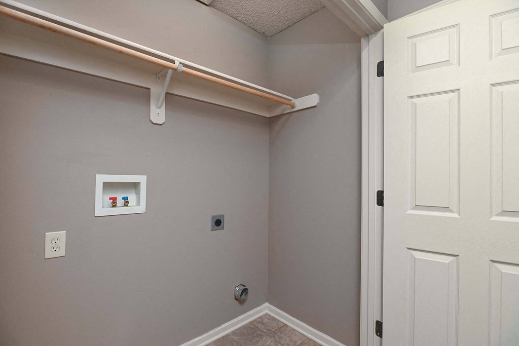 a room with a white door and a shelf on the wall