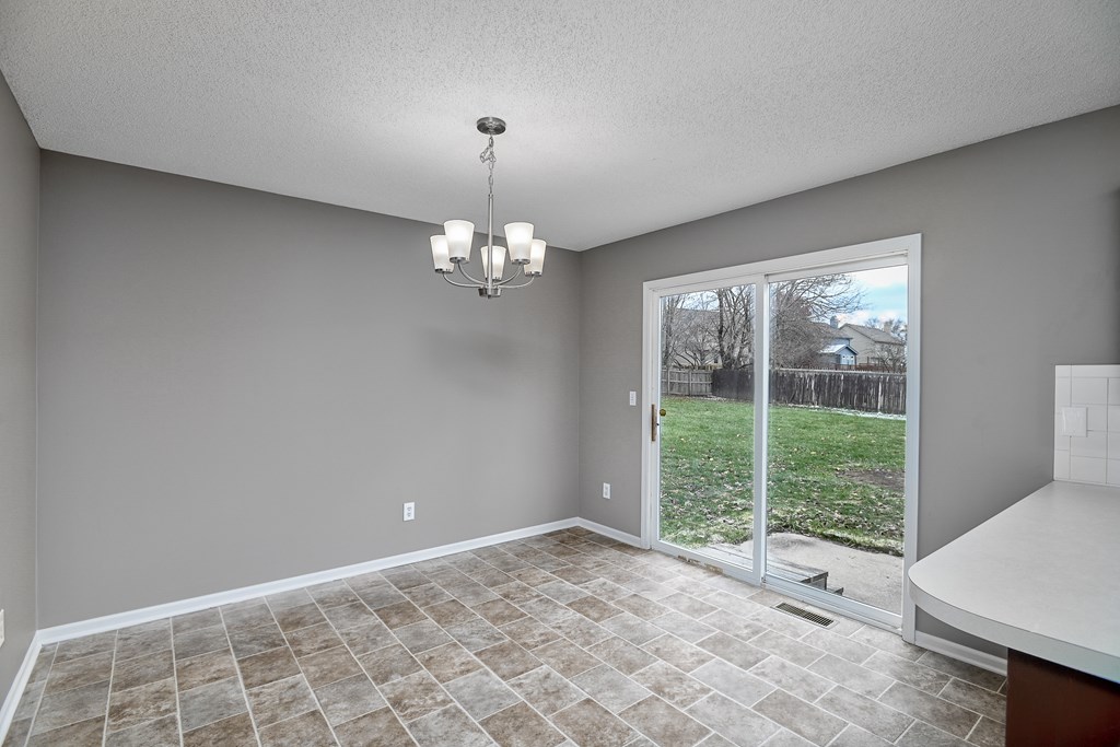 A room with a tiled floor and a chandelier.