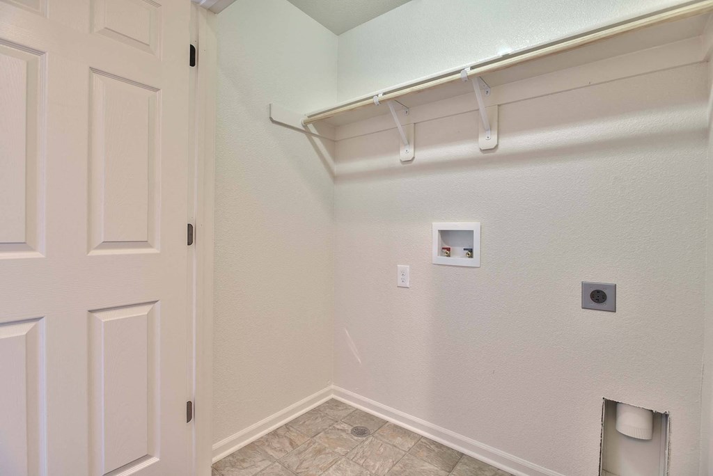 an empty room with a white wall and a white door