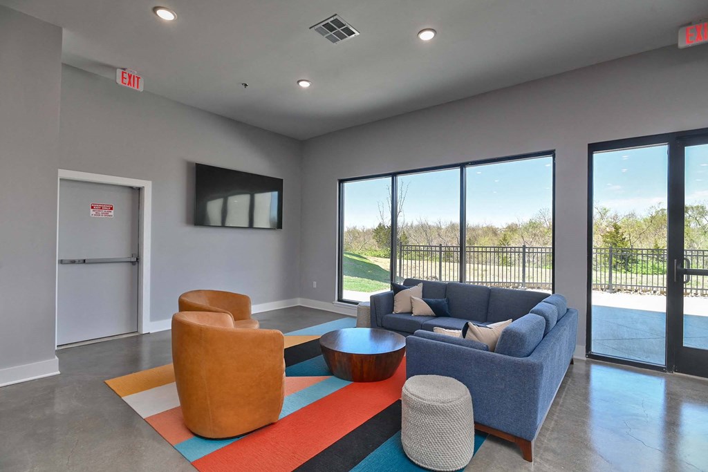 a living room with couches and chairs and a television