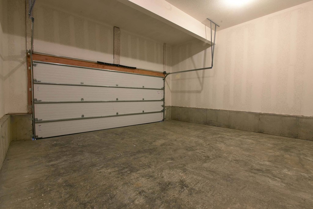 a garage door in a room with a cement floor