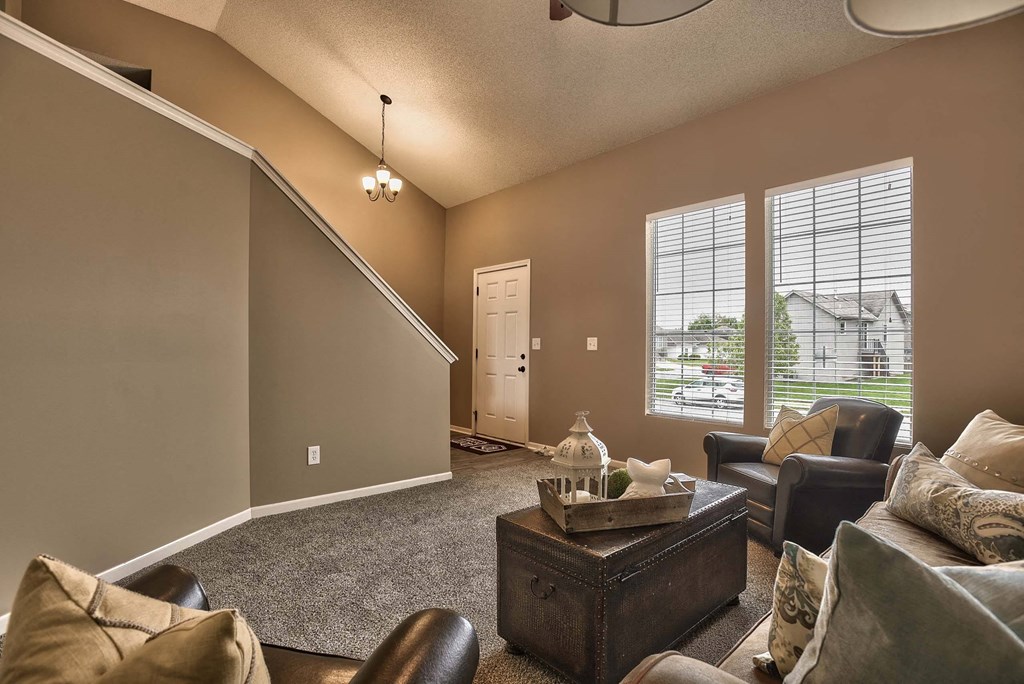 a living room with couches and chairs and a table