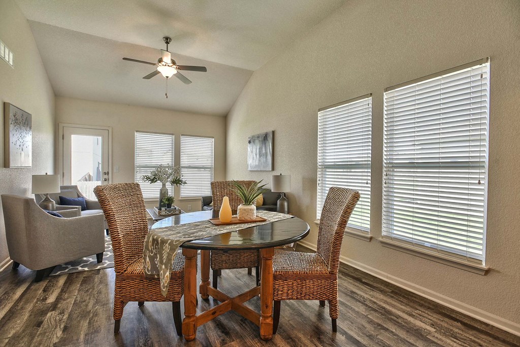 A dining room with a round table and chairs.