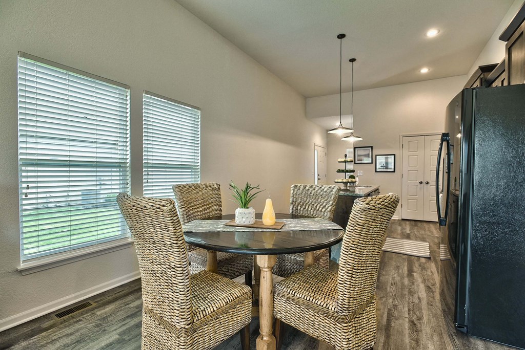 A dining room with a table and chairs.