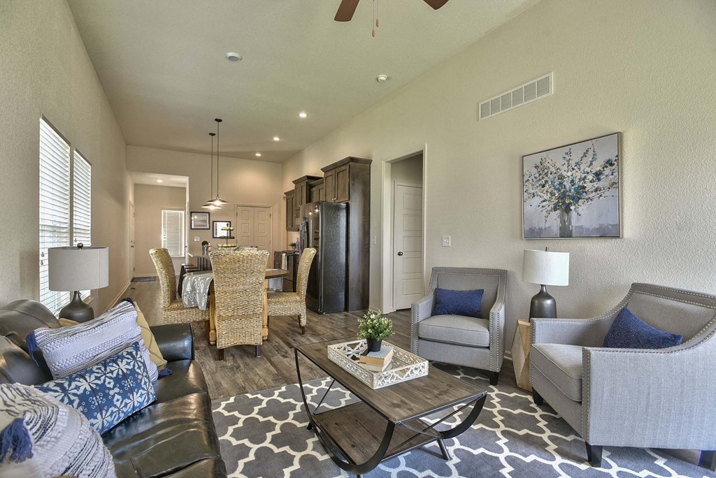 A living room with a black and white rug and a coffee table.