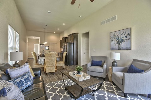 A living room with a black and white rug and a coffee table.