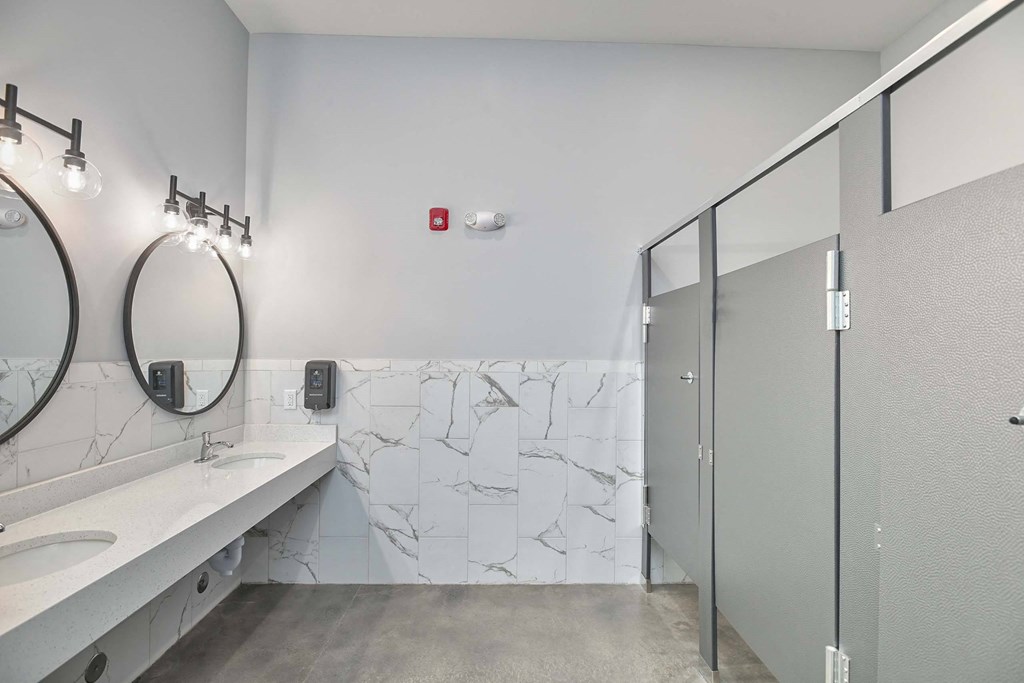 a bathroom with a sink and a mirror and a shower