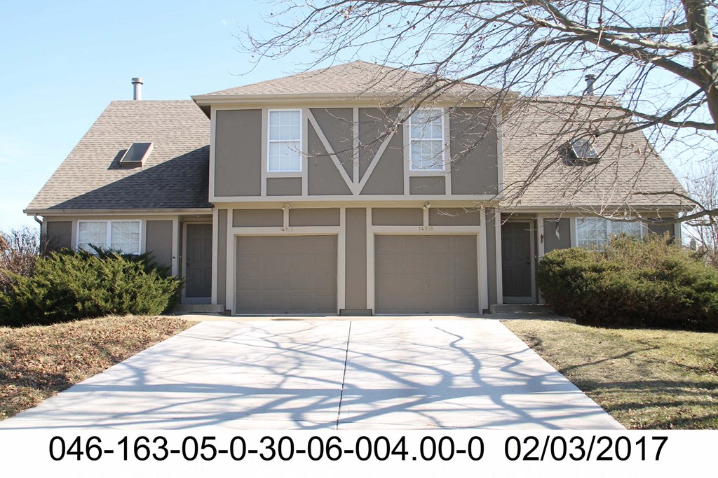 a front view of a house with a garage and a driveway