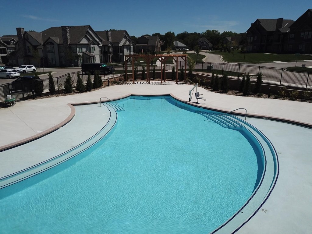 a large swimming pool with houses in the background