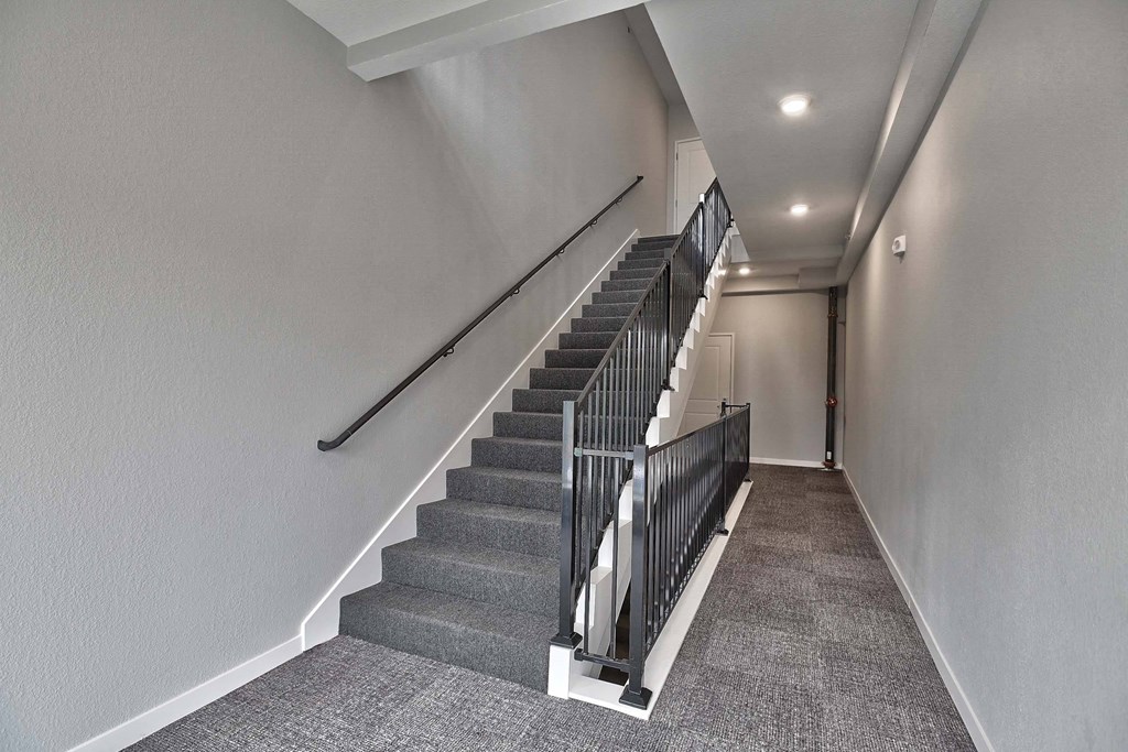 a long staircase with a metal railing up the side of a building