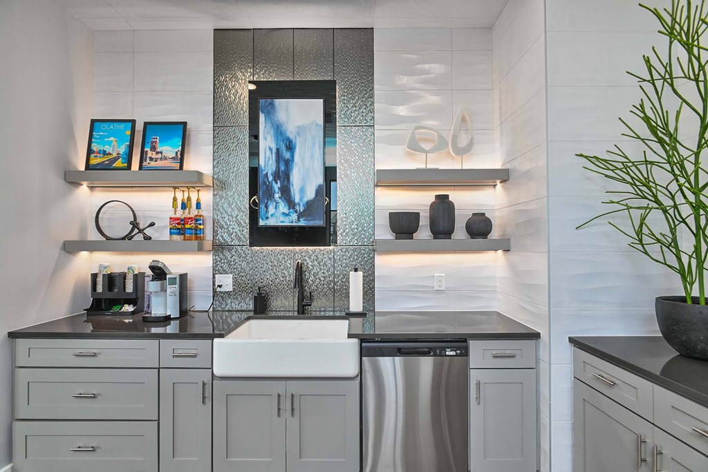 a white kitchen with stainless steel appliances and a sink