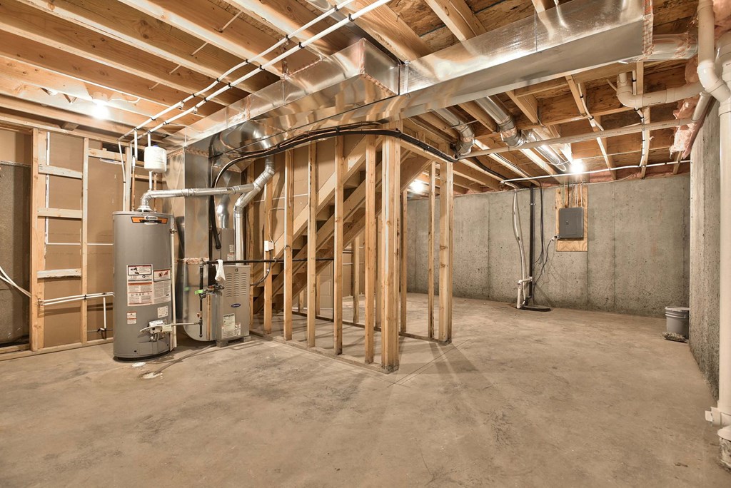 A room under construction with exposed wooden beams and ductwork.
