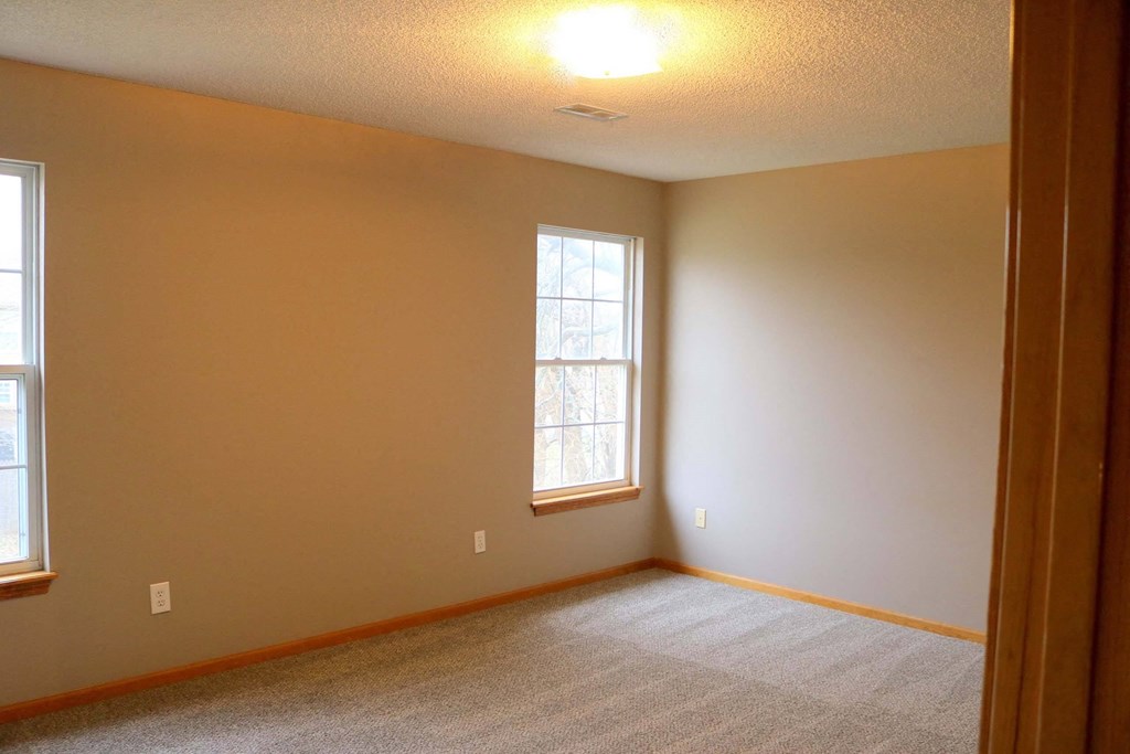 a room with a carpeted floor and a window