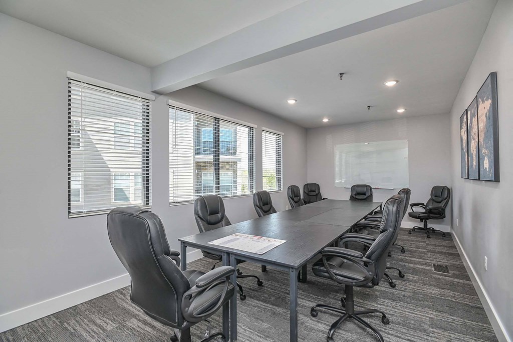 a conference room with a long table and chairs