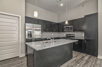 a kitchen with stainless steel appliances and granite counter tops