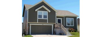 a house with a garage door in front of it
