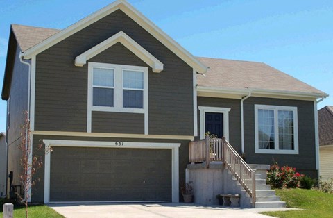 a house with a garage door in front of it