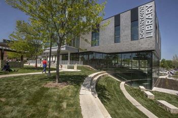 the front of a building with people walking in front of it