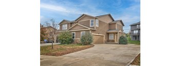 an empty driveway in front of a house