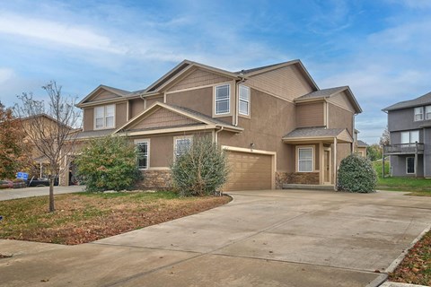 an empty driveway in front of a house