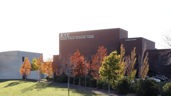 a large building with trees in front of it