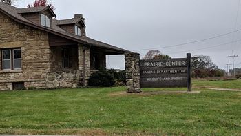 a stone building with a sign in front of it