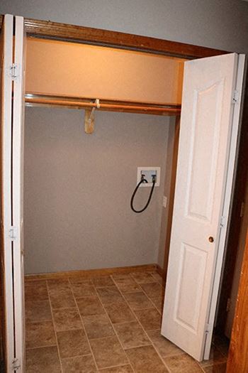 a bathroom with an open door and a shower