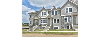 a large house with stone and gray siding