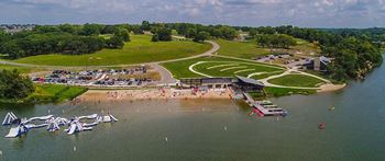 an aerial view of a beach with boats on the water