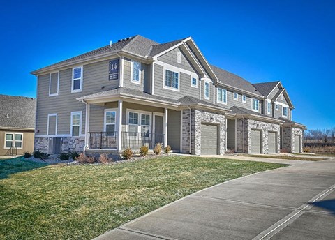 a large house with a sidewalk in front of it