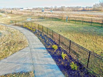 a path running through a park next to a fence
